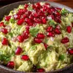 fresh loaded guacamole with pomegranate seeds - featured image